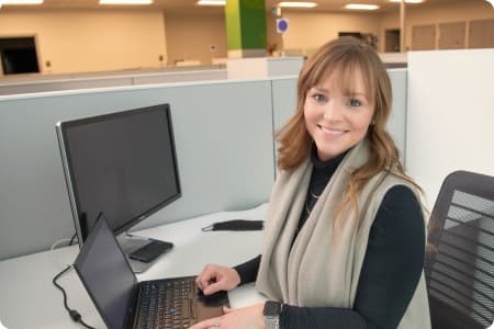 An Image of a woman working on a laptop