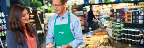 An image with a Sobeys worker assisting his customer