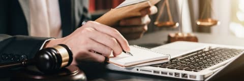 An image of man writing on paper